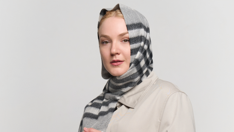 Artisan hands weaving Scottish cashmere on a traditional loom, showcasing premium material.